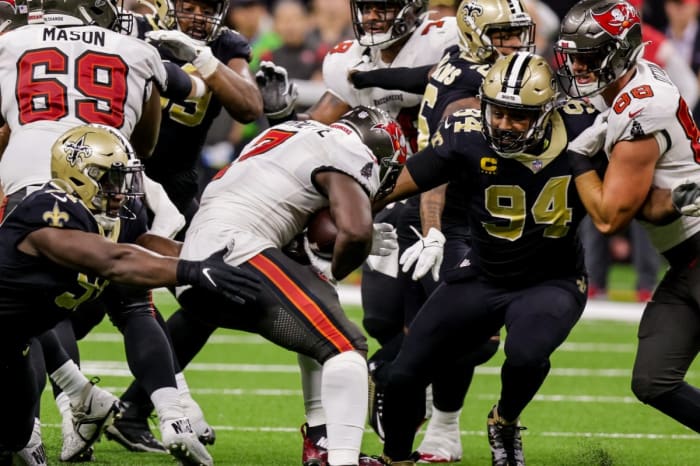 New Orleans Saints defensive end Cameron Jordan (94) tackles Tampa Bay running back Leonard Fournette (7). Mandatory Credit: Stephen Lew-USA TODAY Sports